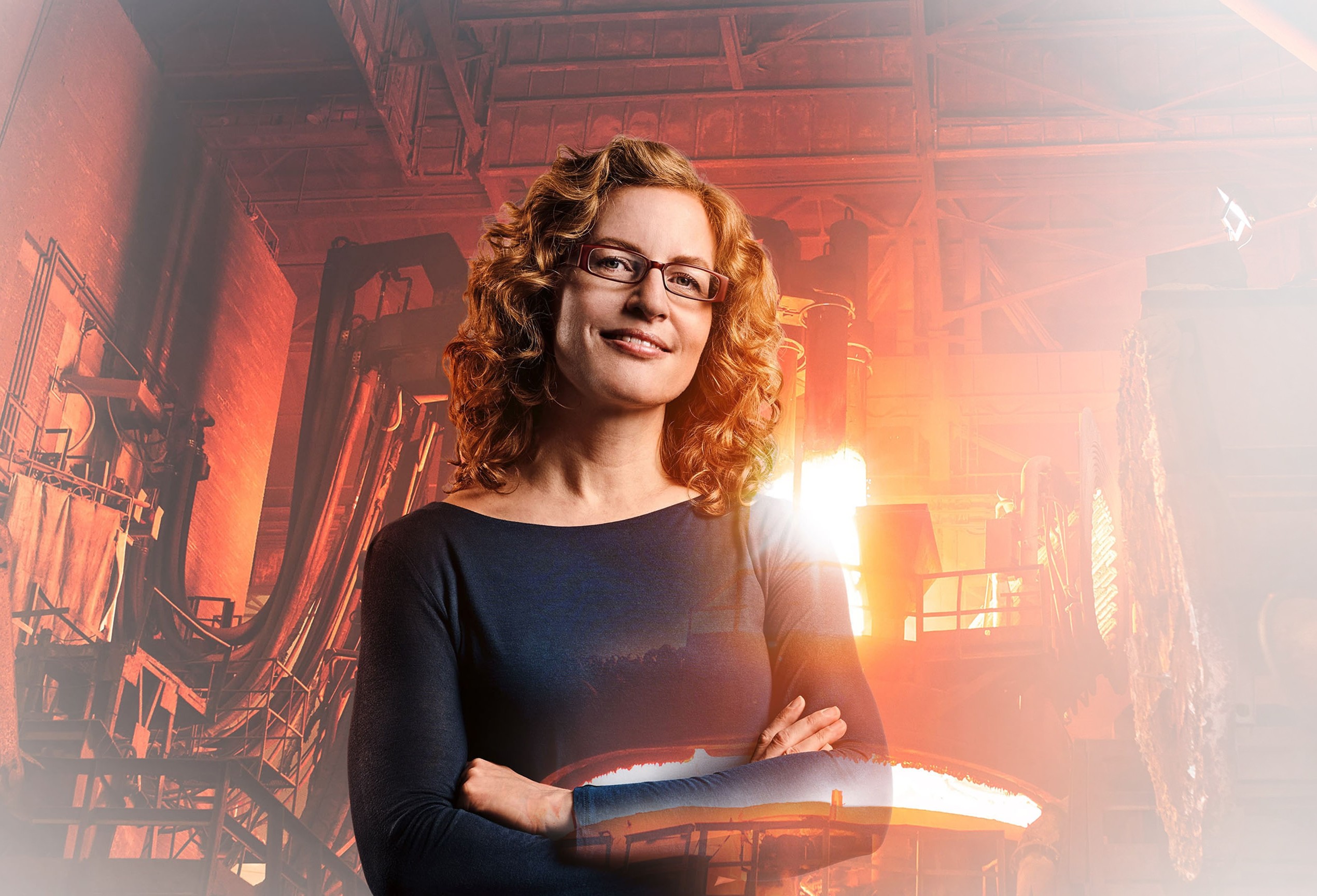 Materials scientist Andrea with foundry and glowing copper in the background