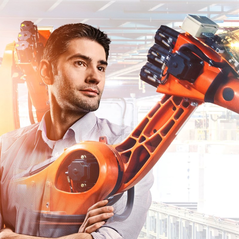 Construction engineer Fabian with production robot in the background
