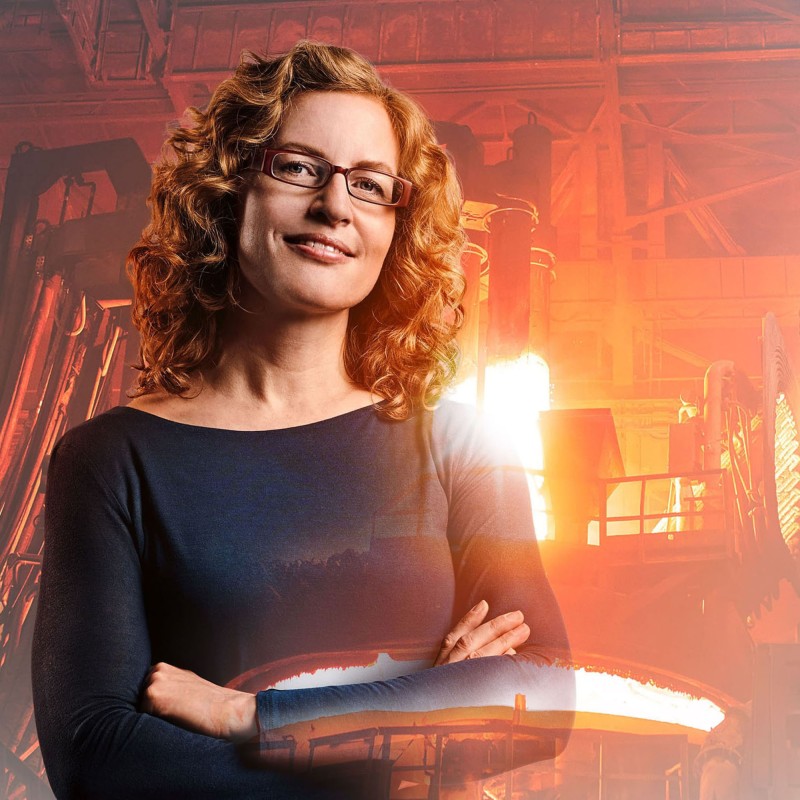 Materials scientist Andrea with foundry and glowing copper in the background