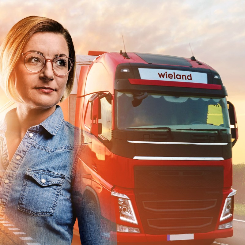 Sales employee Rilana with Wieland truck on the road in the background