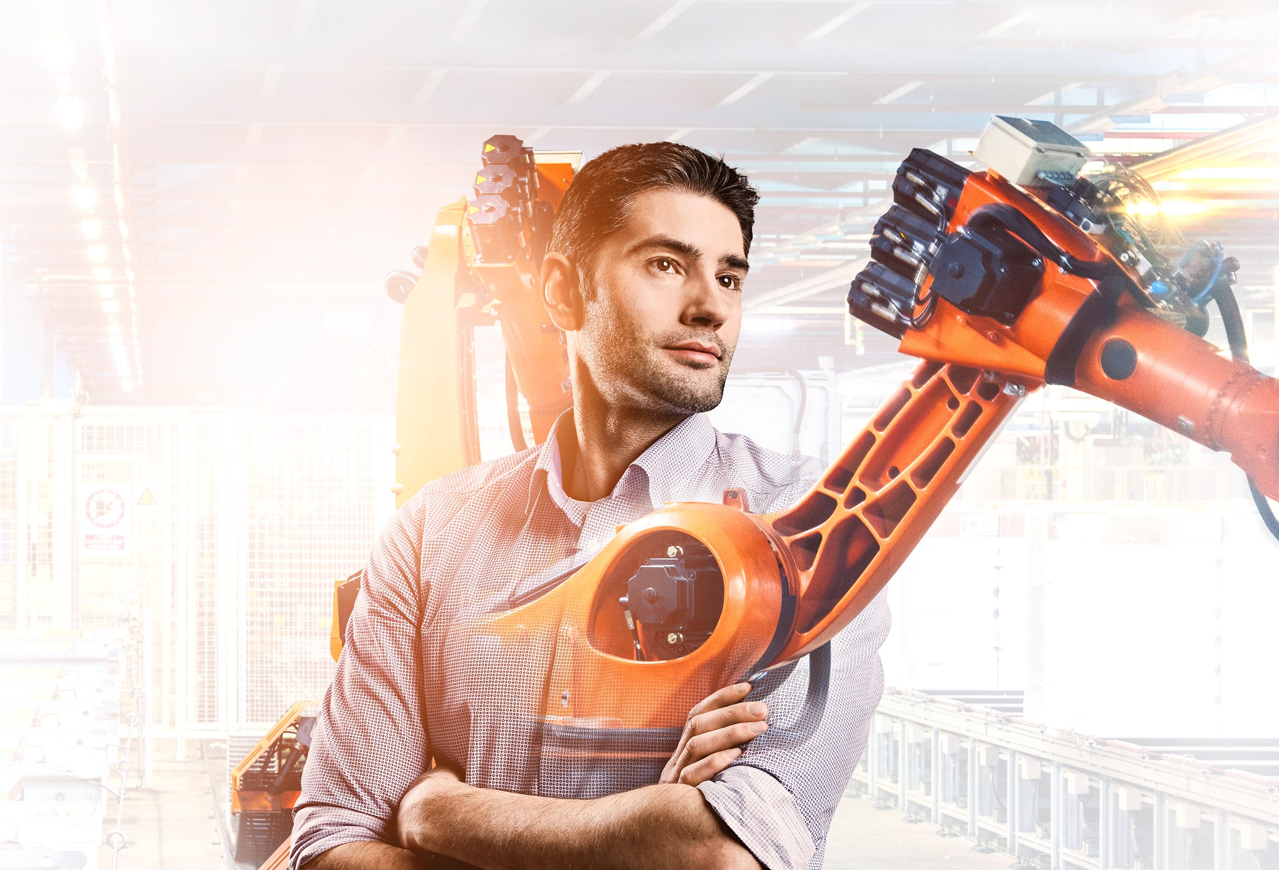Design engineer Fabian with production robot in the background