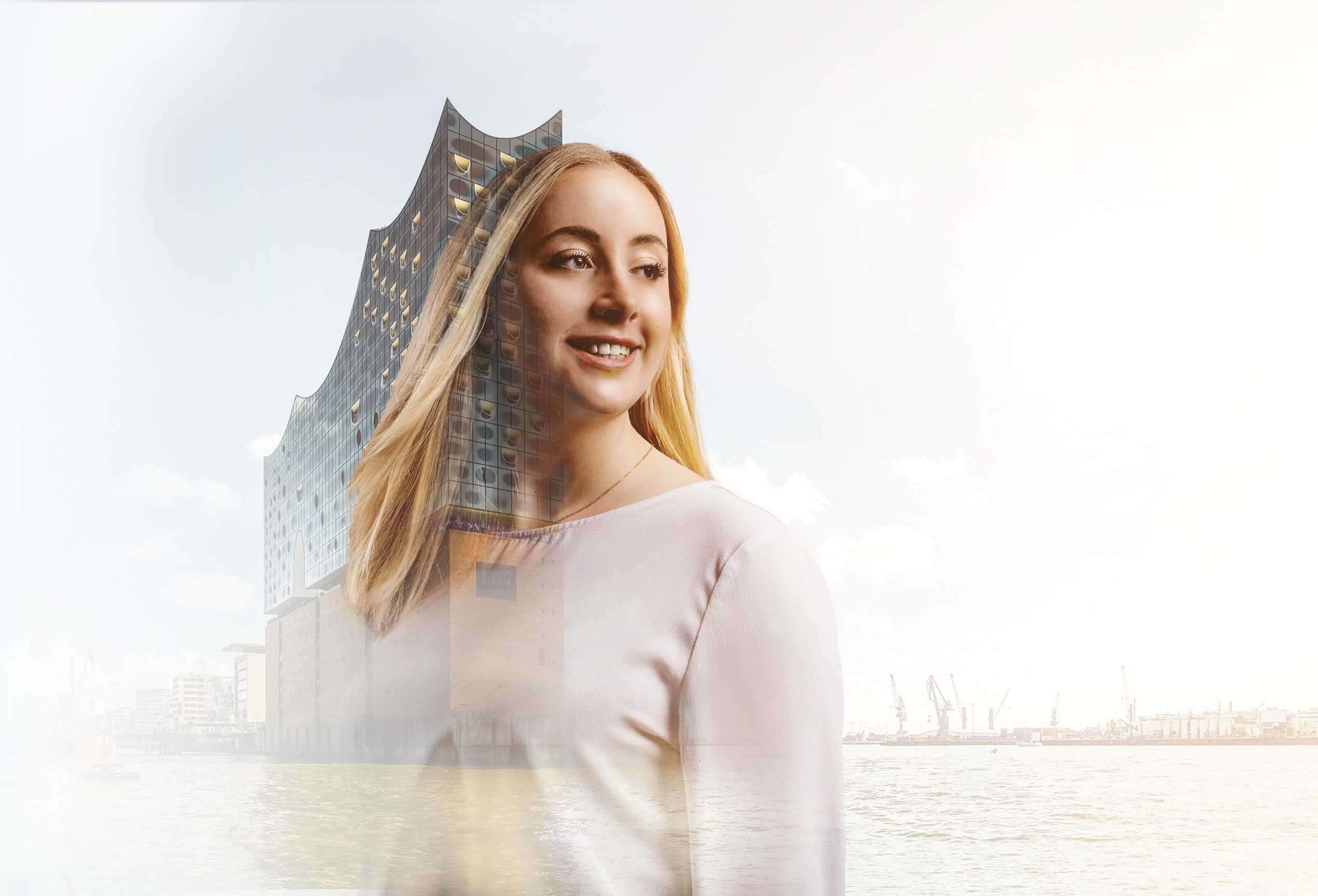 Student Franziska with a view of Hamburg harbour and the Elbphilharmonie in the background
