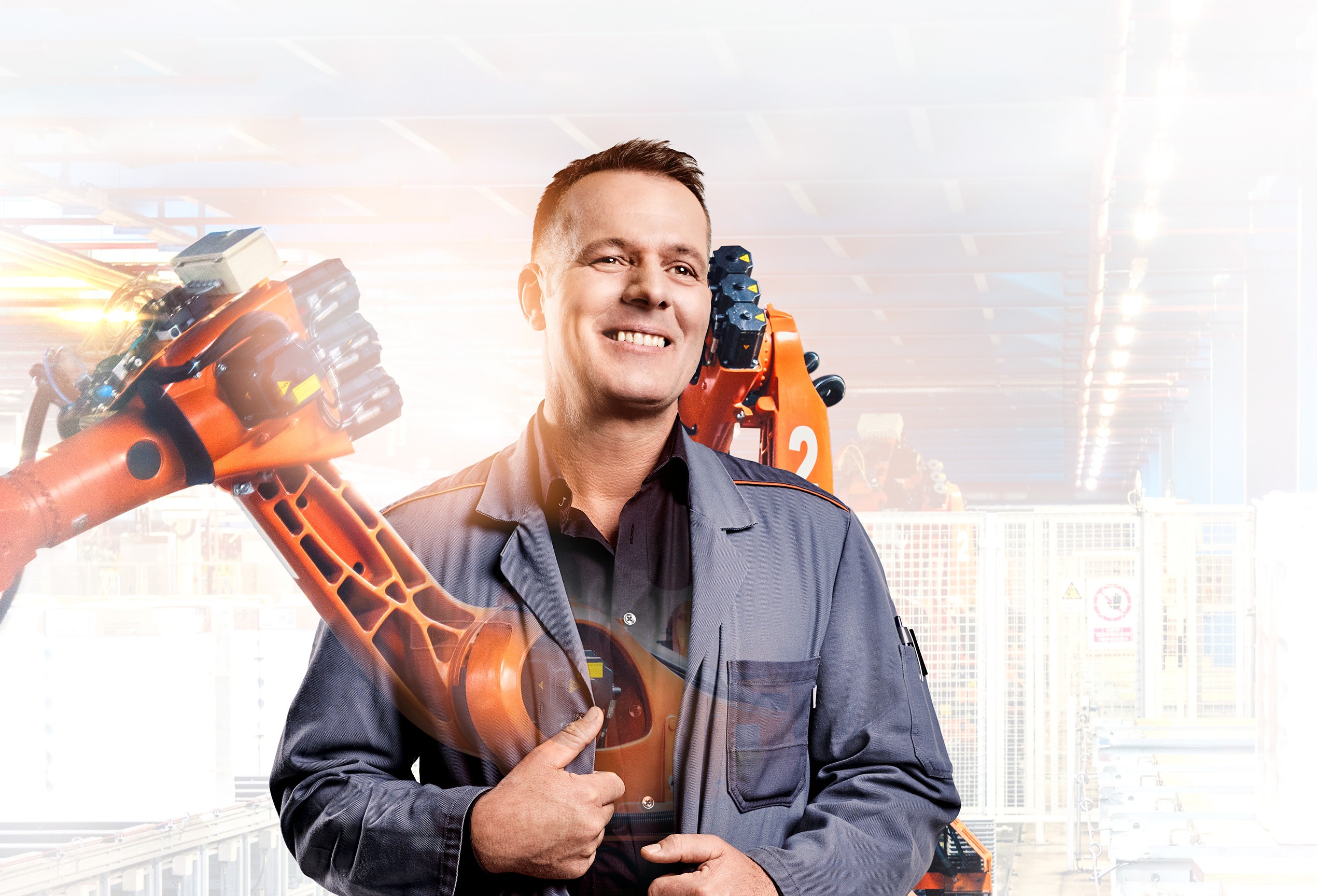 Shift foreman Uwe with robot arm in the background