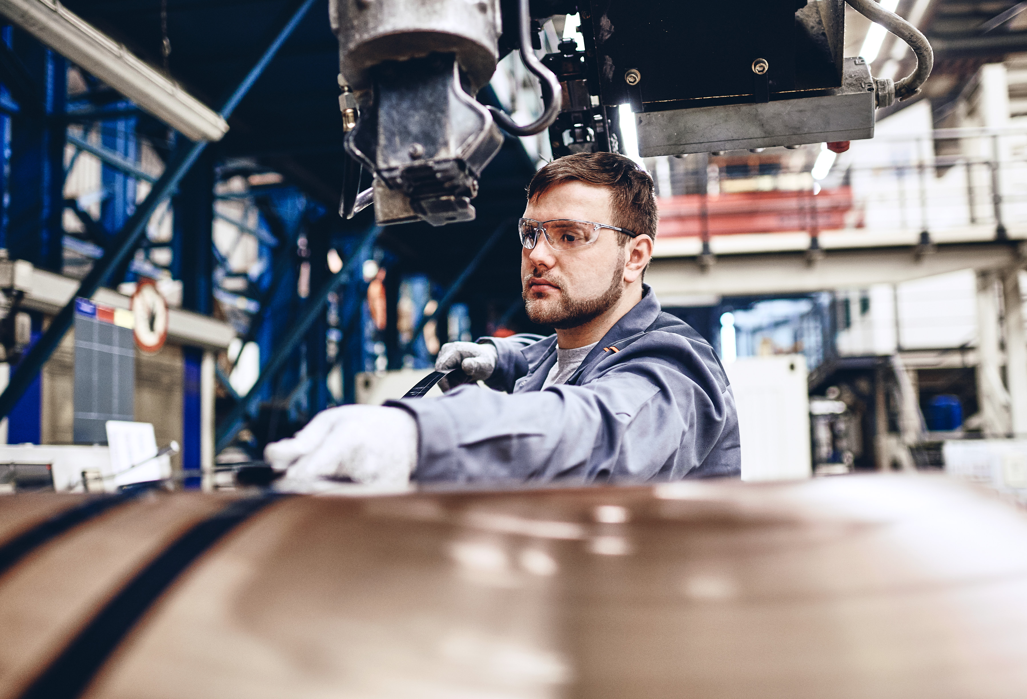 Production specialist wearing safety clothes checking copper products