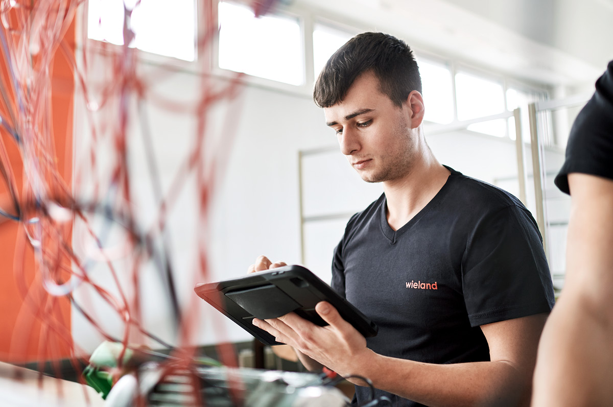 Young mal trainee holding a tablet